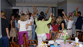This photo is from one of our most recent surprise birthday parties for a 13 year old.  Everyone is doing the YMCA dance.